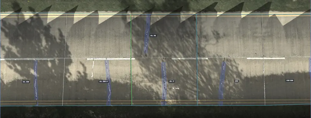Jointed concrete road from directly above, partly in tree shadow, with slab joints outlined and the cracks on each slab traced and labeled with ASTM distress codes