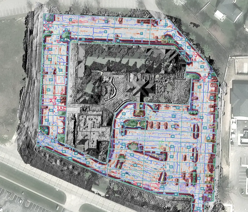 The same parking lot in HALO AI's relief view, with depressions, curbs and islands in red, cracks traced in blue, and the lot divided into numbered sample units